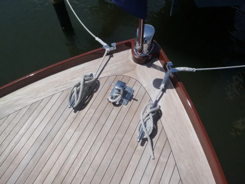 Slide: The Image of 1949 Rybovich Sport Fish boat deck with ropes and cleats. - 17