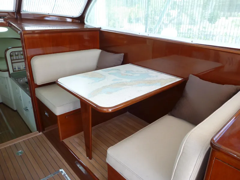 Slide: The Image of 1949 Rybovich Sport Fish interior with wooden table and cushioned seating. - 20