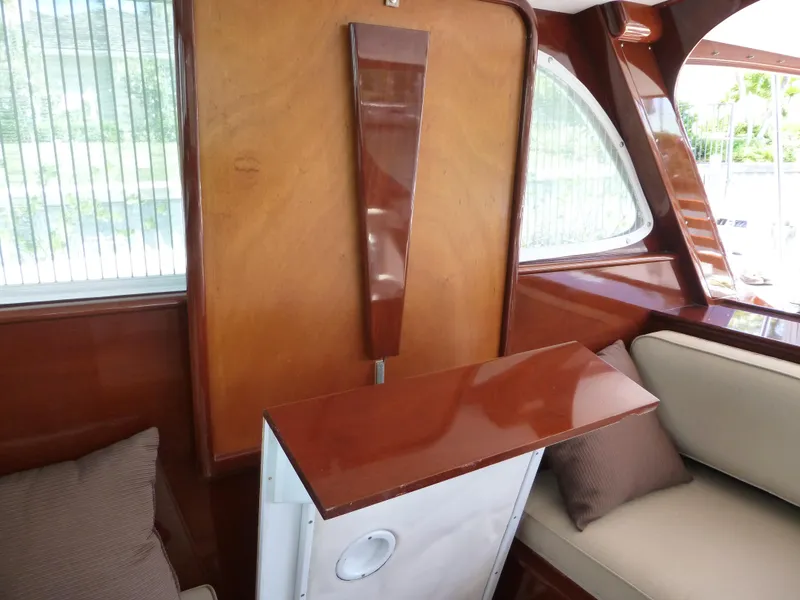 Slide: The Image of Interior of a 1949 Rybovich Sport Fish boat with polished wood and cushioned seating. - 21