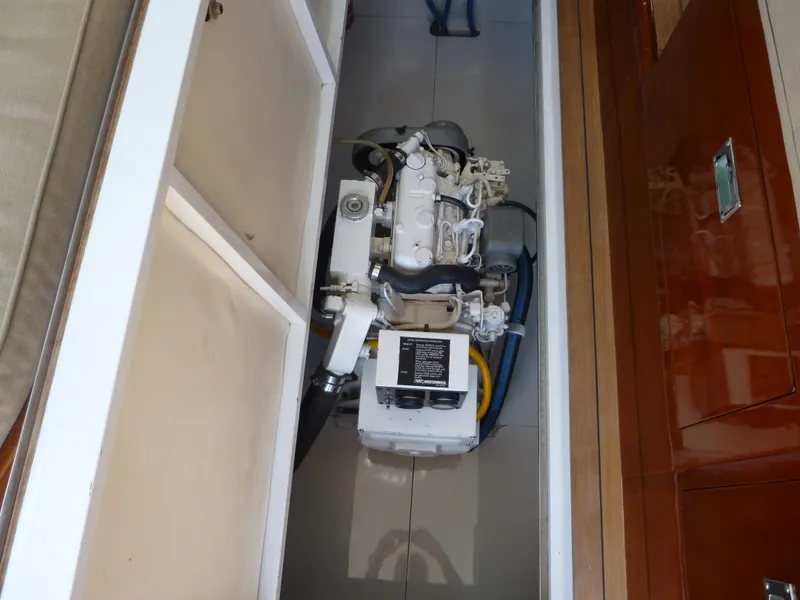 Slide: The Image of 1949 Rybovich Sport Fish engine compartment with visible machinery and components. - 23