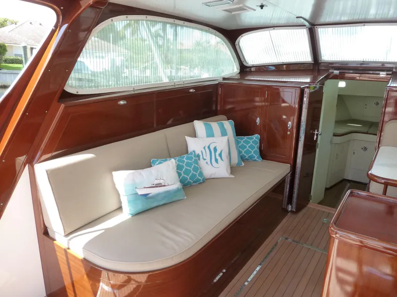 Slide: The Image of 1949 Rybovich Sport Fish interior with cushioned seating and decorative pillows. - 24