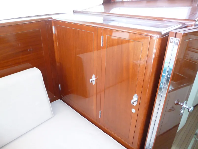 Slide: The Image of 1949 Rybovich Sport Fish interior with polished wooden cabinetry and white seating. - 27