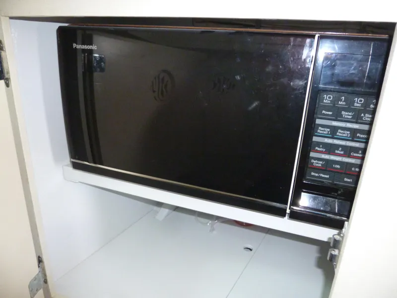 Slide: The Image of Panasonic microwave oven with digital controls, installed in a kitchen cabinet. - 38