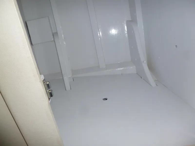 Slide: The Image of Interior of a 1949 Rybovich Sport Fish boat, showing a white compartment. - 39