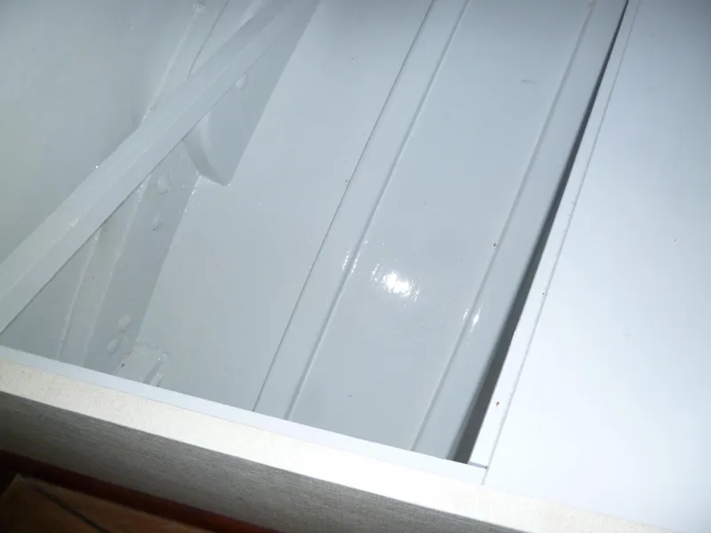 Slide: The Image of Interior view of a 1949 Rybovich Sport Fish boat, showcasing white painted surfaces. - 44