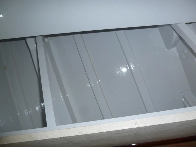 Slide: The Image of Interior view of a 1949 Rybovich Sport Fish boat, showcasing white painted surfaces. - 45
