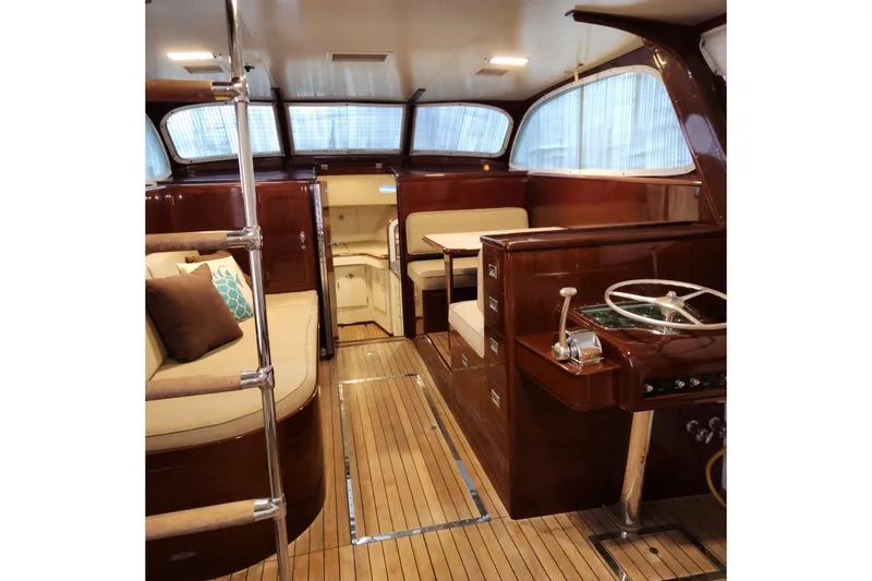 Slide: The Image of 1949 Rybovich Sport Fish boat interior with polished wood and cushioned seating. - 54