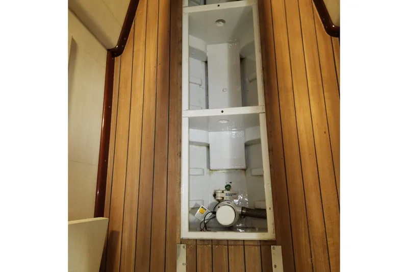 Slide: The Image of 1949 Rybovich Sport Fish interior with wooden flooring and storage compartment. - 56
