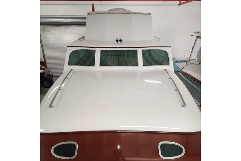 Slide: The Image of 1949 Rybovich Sport Fish boat with classic design in a storage facility. - 94