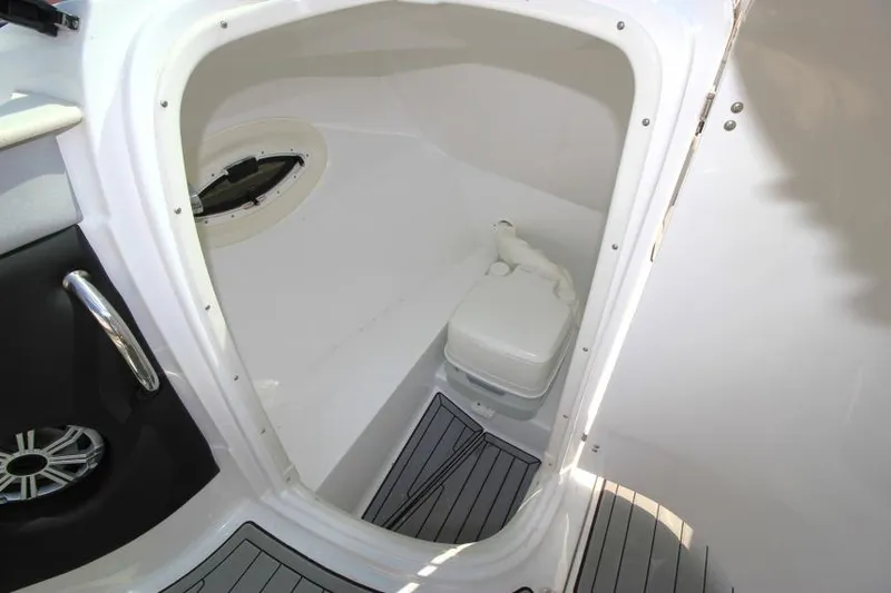 Slide: The Image of 2015 Cruisers Sport Series 238 Bow Rider boat interior with compact toilet. - 24