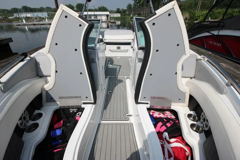Slide: The Image of 2015 Cruisers Sport Series 238 Bow Rider interior with open storage compartments and seating. - 29