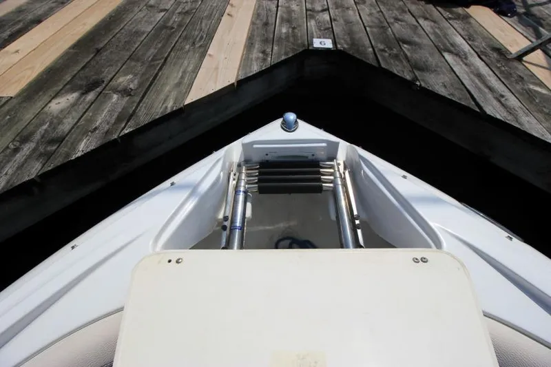 Slide: The Image of 2015 Cruisers Sport Series 238 Bow Rider at dock, showing bow ladder and deck. - 31