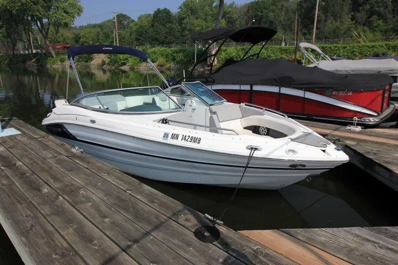 The Image of 2015 Cruisers Sport Series 238 Bow Rider docked on a calm lake. - 6