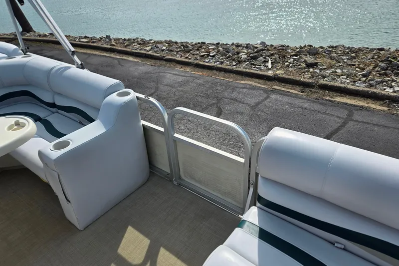 Slide: The Image of Interior view of a 1999 Bennington 2275LX pontoon boat with cushioned seating. - 11