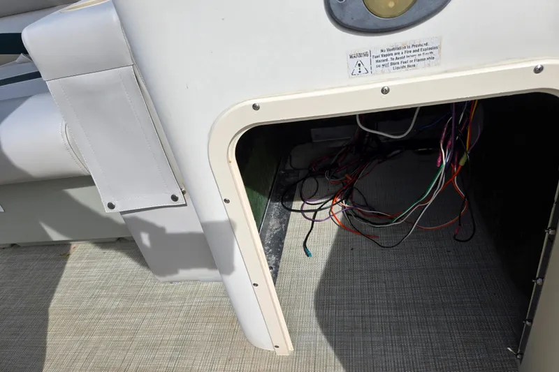 Slide: The Image of Open compartment with exposed wiring on a 1999 Bennington 2275LX boat. - 12