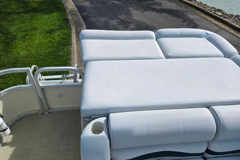 Slide: The Image of 1999 Bennington 2275LX pontoon boat with spacious white seating and cup holder. - 16