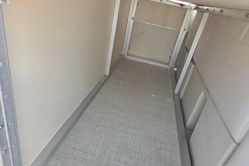 Slide: The Image of Interior view of a 1999 Bennington 2275LX boat storage compartment with metal framing. - 18