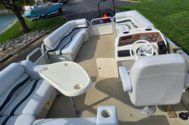 Slide: The Image of 1999 Bennington 2275LX pontoon boat interior with plush seating and steering console. - 20