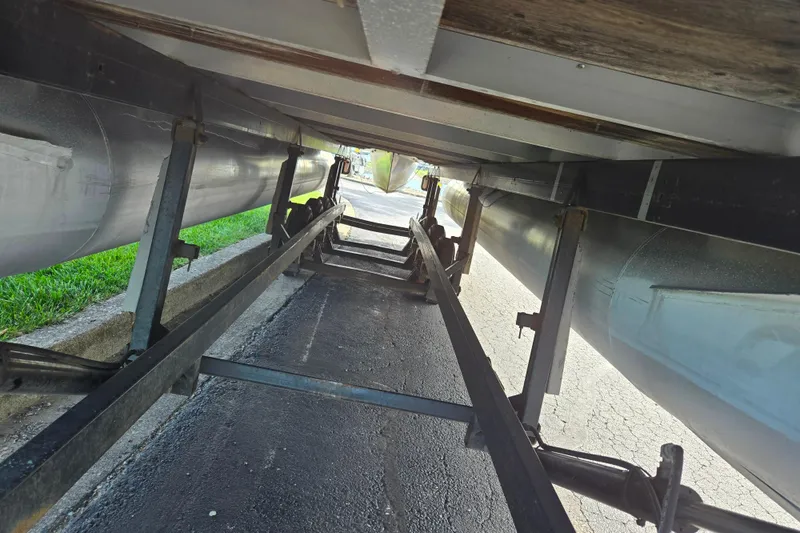 Slide: The Image of Underneath view of a 1999 Bennington 2275LX pontoon boat on a trailer. - 7
