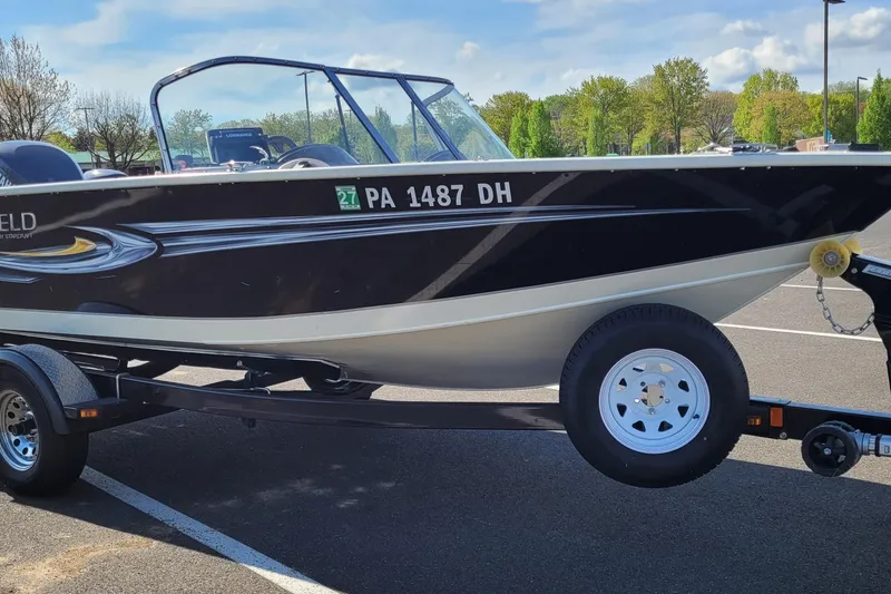 The Image of 2011 Starweld 1800 boat on trailer in parking lot, sunny day. - 1