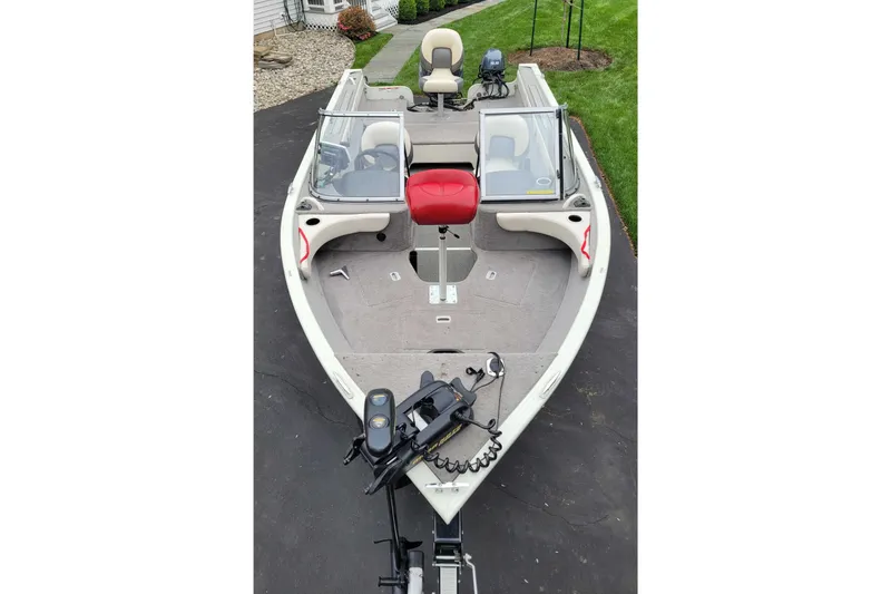 Slide: The Image of Starweld 1800 boat, 2011 model, featuring dual windshields and a red seat on a driveway. - 12