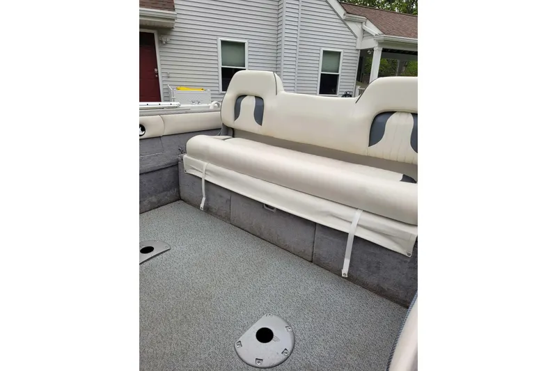 Slide: The Image of Interior of a 2011 Starweld 1800 boat with cushioned seating and carpeted flooring. - 13