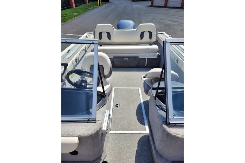 Slide: The Image of Interior view of a 2011 Starweld 1800 boat, featuring seating and steering console. - 14