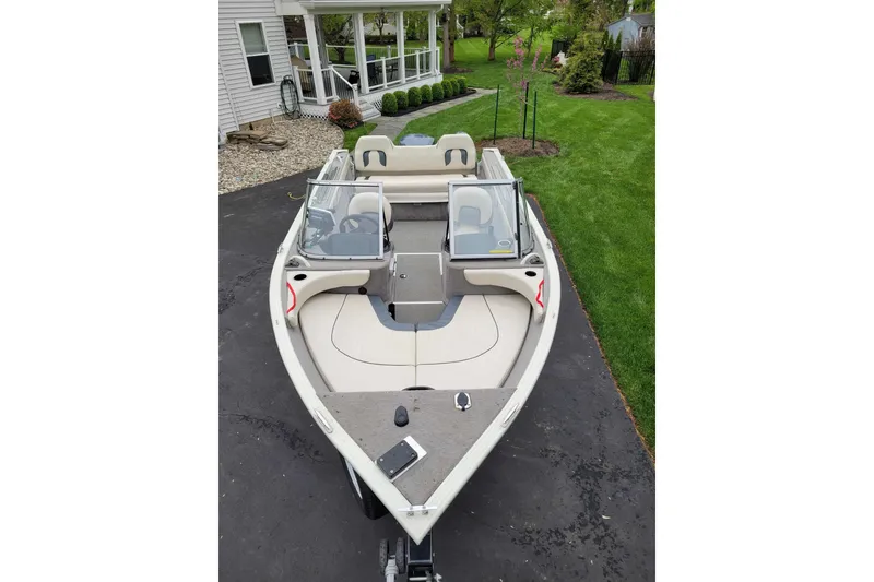 Slide: The Image of 2011 Starweld 1800 boat parked on driveway near a house and garden. - 15