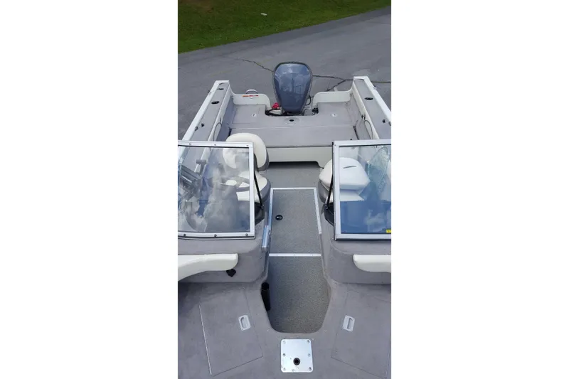 Slide: The Image of 2011 Starweld 1800 boat interior with seating and windshield, parked on pavement. - 16