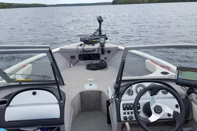 Slide: The Image of Starweld 1800 boat interior, 2011 model, featuring steering wheel and navigation equipment on a lake. - 17