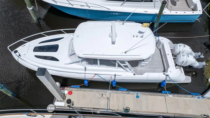 Slide: The Image of 2022 Intrepid 345 Valor boat docked, aerial view, showcasing sleek design and twin engines. - 31