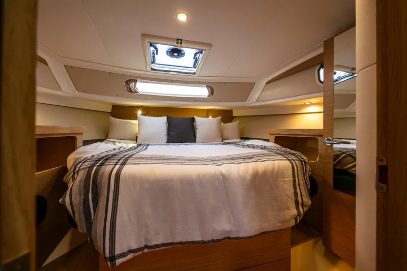 Slide: The Image of Luxurious cabin interior of 2022 Nimbus 365 Coupe with cozy bedding and ambient lighting. - 15