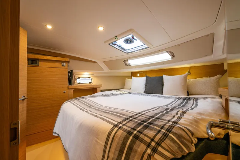 Slide: The Image of Luxurious cabin interior of 2022 Nimbus 365 Coupe with cozy bedding and modern design. - 16