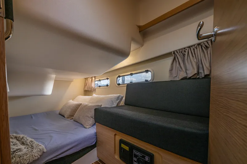 Slide: The Image of Interior cabin of 2022 Nimbus 365 Coupe, featuring cozy bed and seating area. - 20