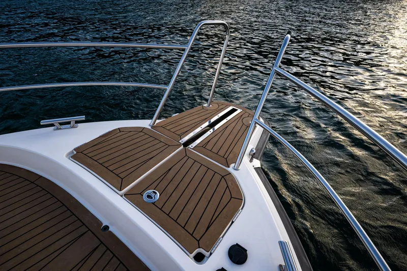 Slide: The Image of Bow of 2022 Nimbus 365 Coupe with teak decking on calm water. - 26