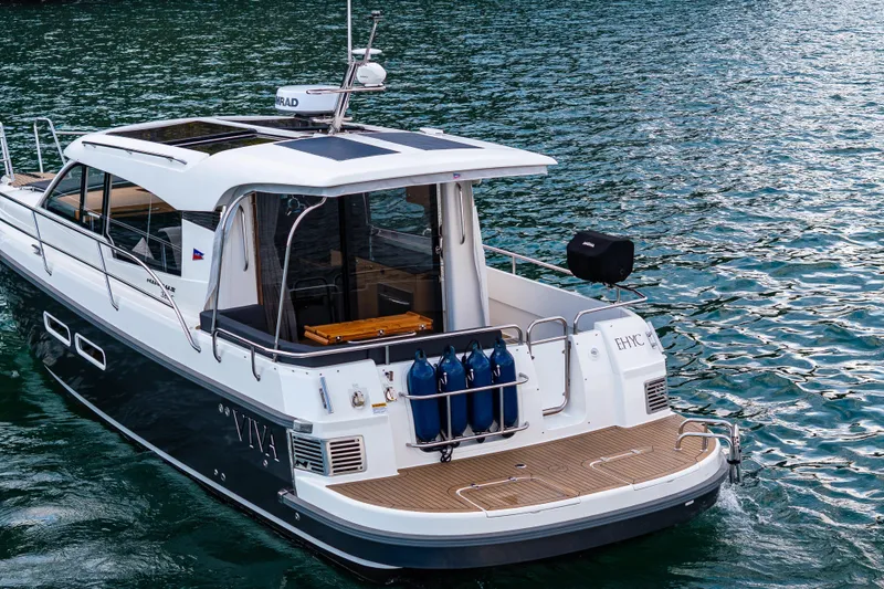 Slide: The Image of 2022 Nimbus 365 Coupe cruising on serene waters, showcasing sleek design and modern features. - 3
