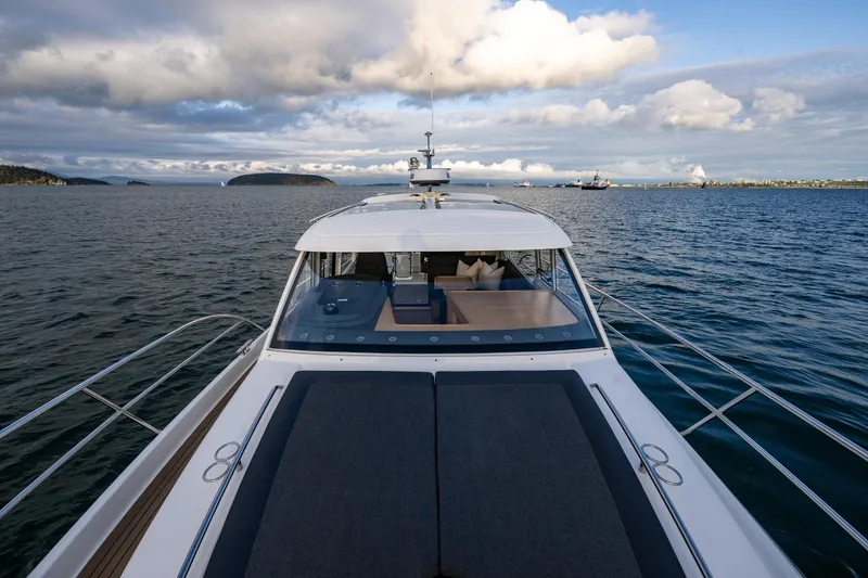 Slide: The Image of 2022 Nimbus 365 Coupe yacht cruising on open water under a cloudy sky. - 37