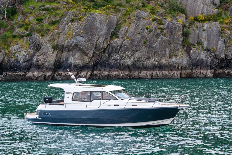 Slide: The Image of 2022 Nimbus 365 Coupe cruising near rocky shoreline. - 38