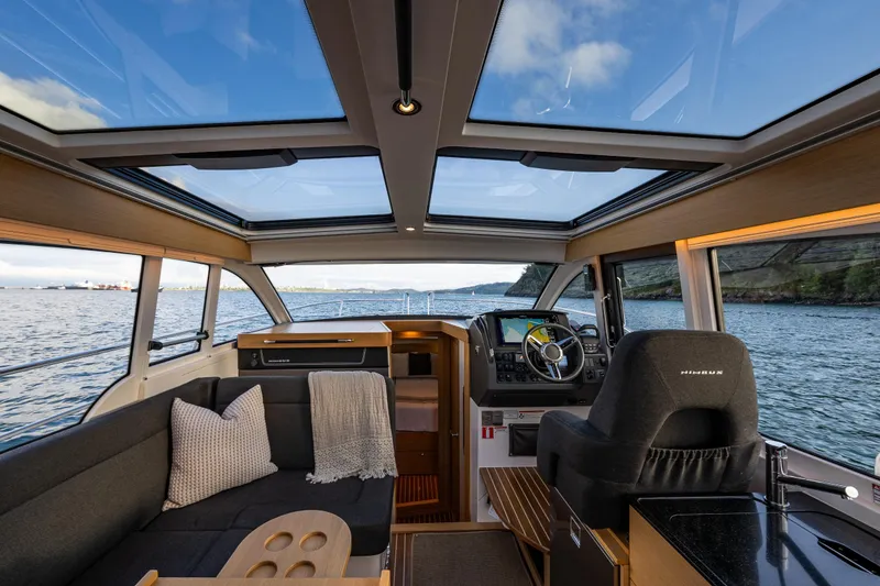 Slide: The Image of Interior of 2022 Nimbus 365 Coupe boat with panoramic windows and modern helm. - 4