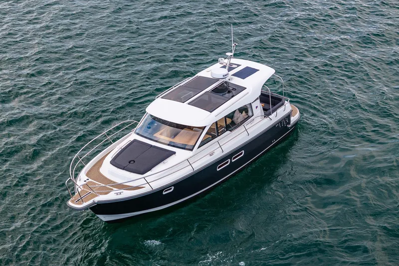 Slide: The Image of 2022 Nimbus 365 Coupe cruising on open water, showcasing sleek design and modern features. - 40