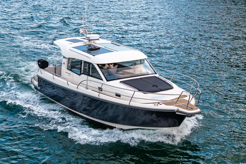Slide: The Image of 2022 Nimbus 365 Coupe cruising on open water, showcasing sleek design and modern features. - 43