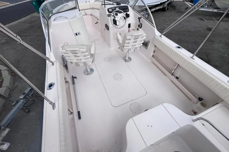 Slide: The Image of 2006 Grady-White Tournament 205 boat interior with seating and steering console. - 14