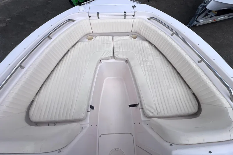 Slide: The Image of 2006 Grady-White Tournament 205 boat interior with white cushioned seating. - 16
