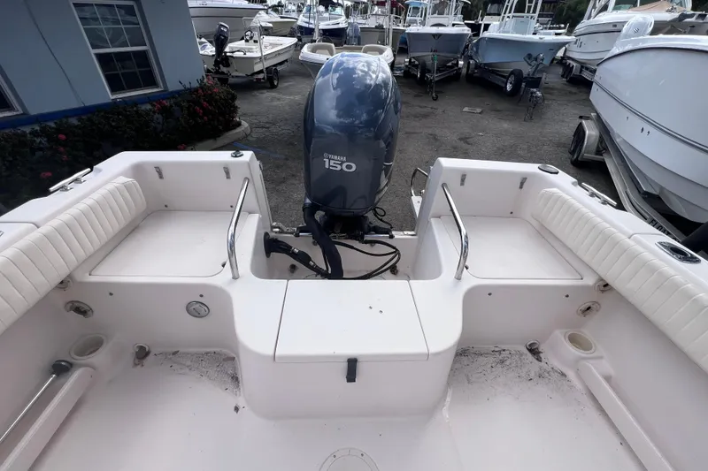 Slide: The Image of 2006 Grady-White Tournament 205 boat with Yamaha 150 engine in a marina setting. - 17