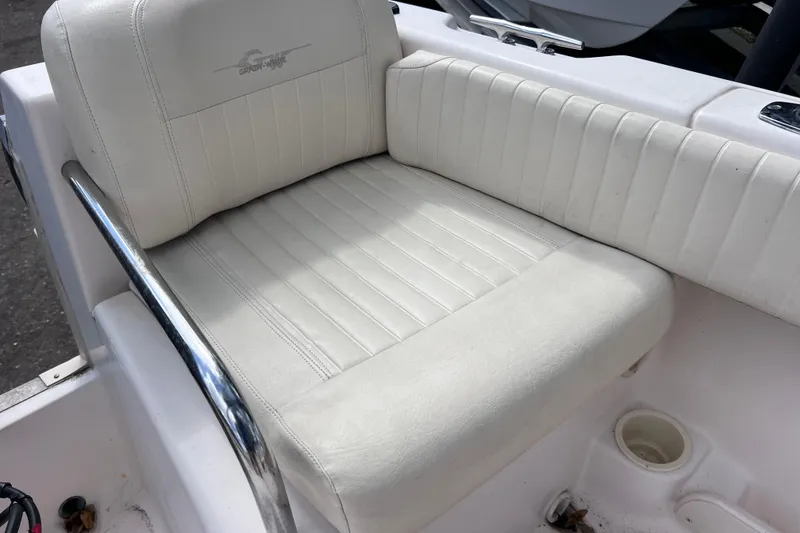 Slide: The Image of White cushioned seat on 2006 Grady-White Tournament 205 boat, featuring sleek metal railing. - 19