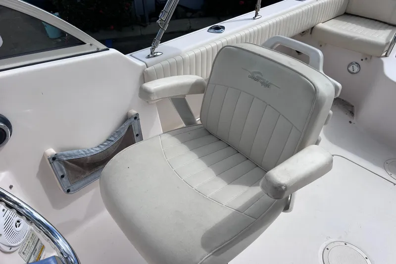 Slide: The Image of 2006 Grady-White Tournament 205 boat interior with cushioned seating and storage. - 21