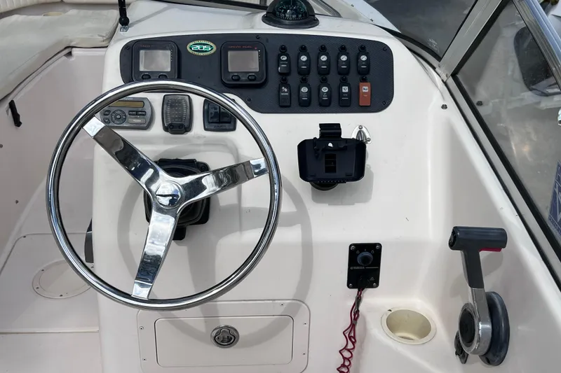Slide: The Image of 2006 Grady-White Tournament 205 boat dashboard with steering wheel and control panel. - 22