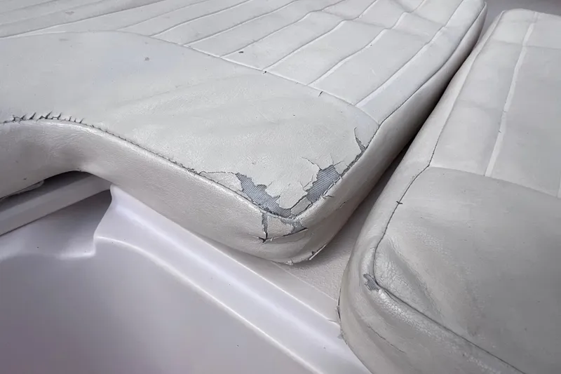 Slide: The Image of Worn upholstery on a 2006 Grady-White Tournament 205 boat seat. - 26