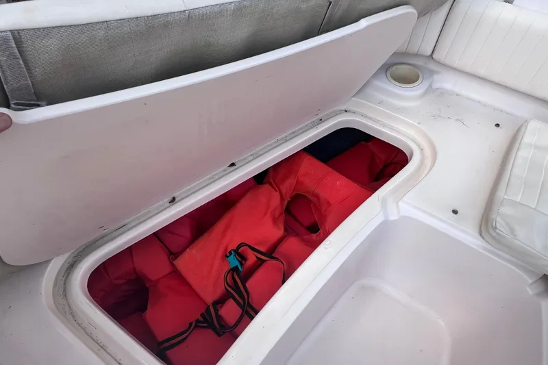 Slide: The Image of Storage compartment with life jackets on a 2006 Grady-White Tournament 205 boat. - 27
