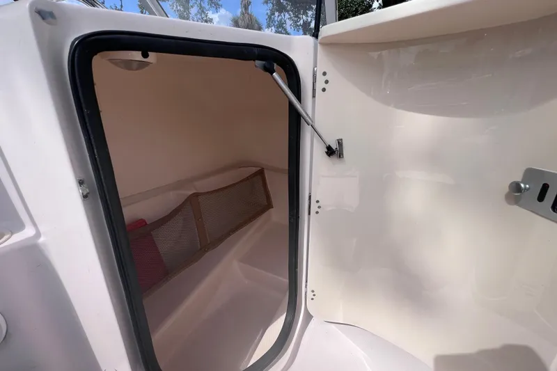 Slide: The Image of 2006 Grady-White Tournament 205 boat interior cabin with open door and storage net. - 31